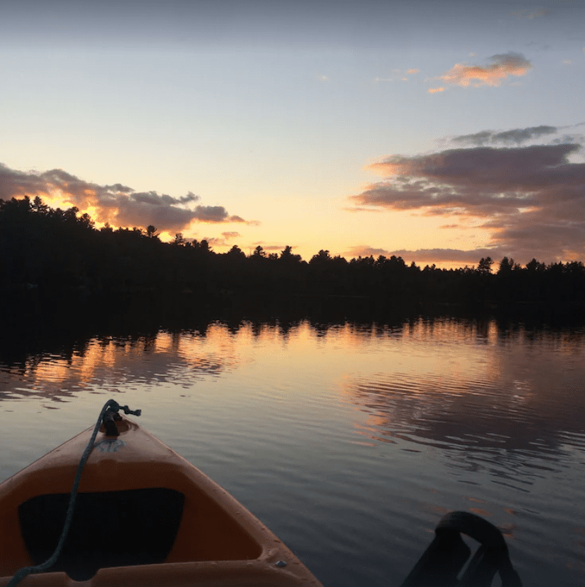 A yellow kayak on Messer Pond at sunset