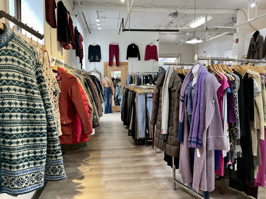 A consignment shop filled with racks and racks of nice women's clothing.
