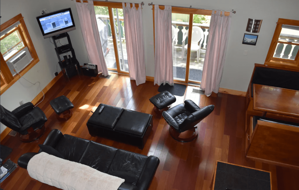 The living room of a chalet with black furniture taken from the second story