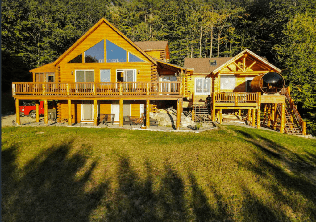 Front view of a two story log home with a porch