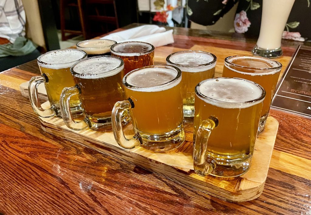 A sampler platter with eight small beers.