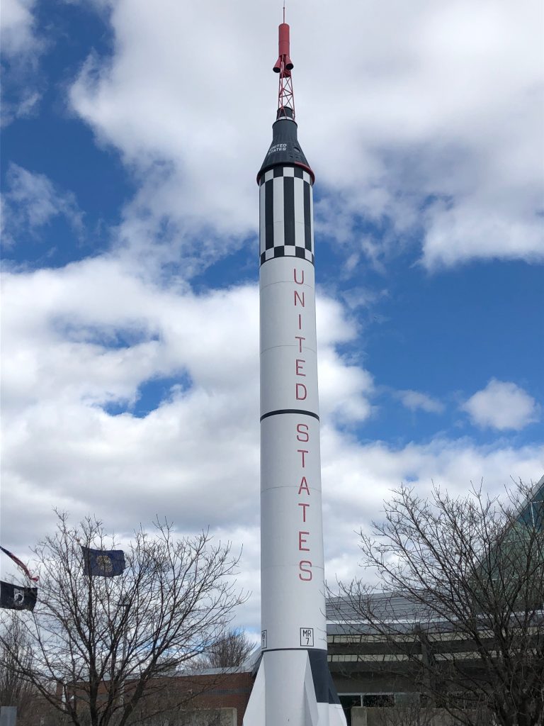 A white rocket reading "United States" perched outside a building.